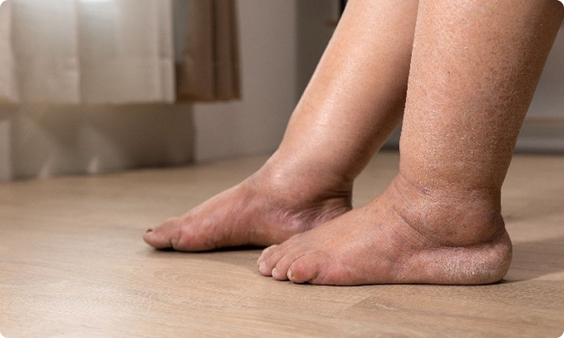 Close-up of a person's feet on a wooden floor
